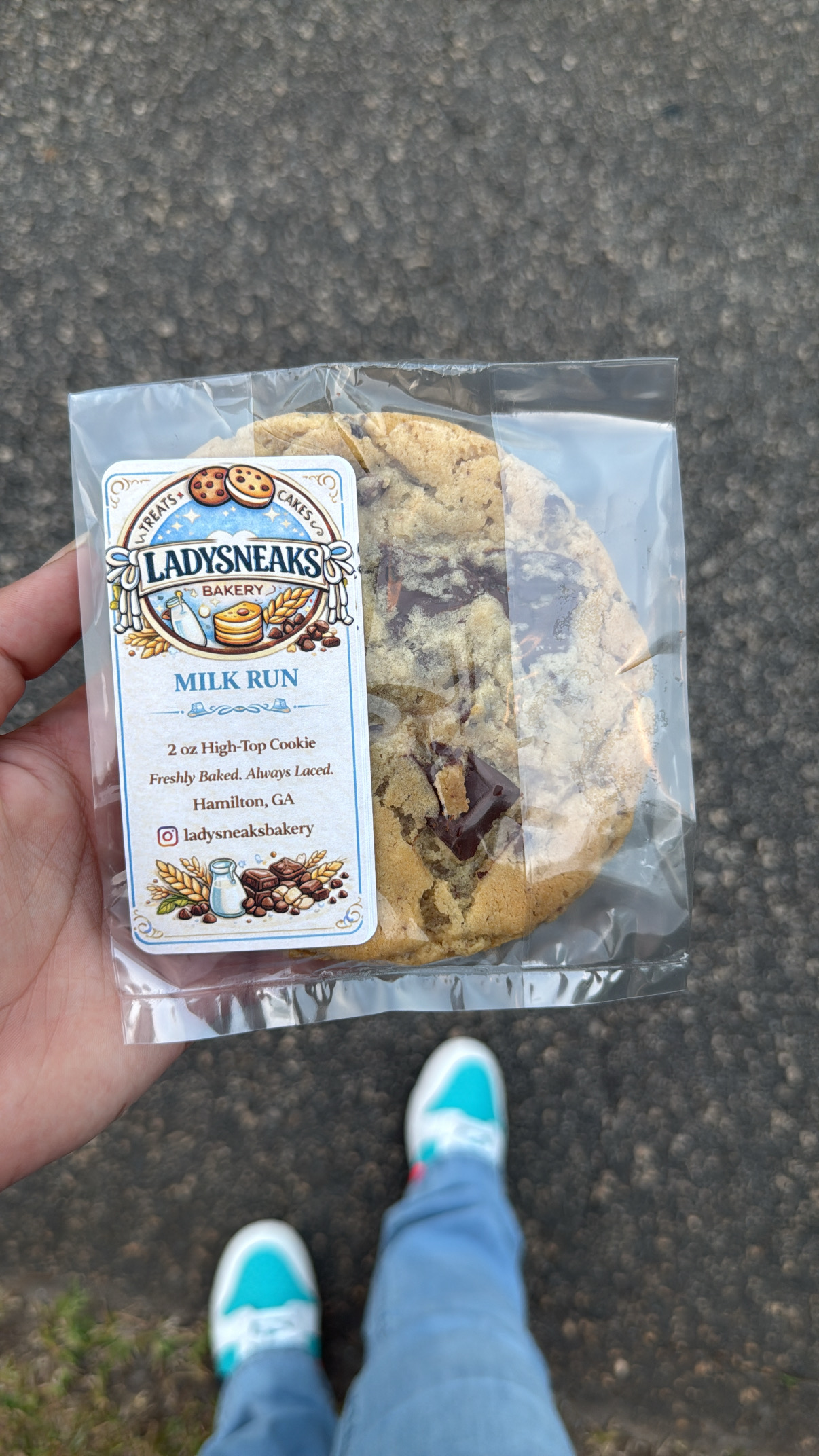 A packaged LadySneaks Milk Run cookie held in hand